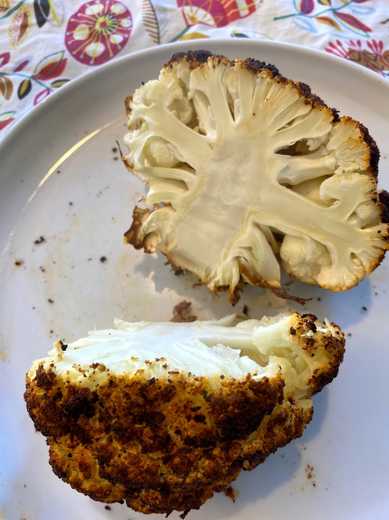 A roasted cauliflower cut in half 