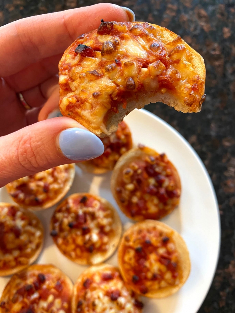 taking a bite out out pepperoni pizza bagel