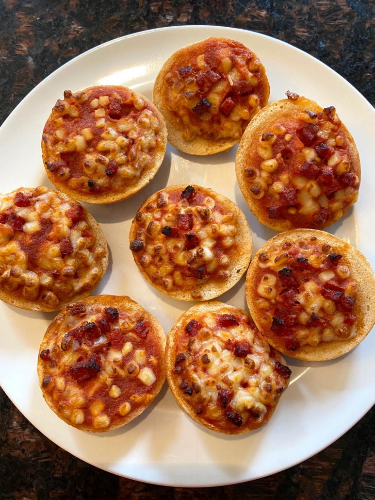 pizza bagel bites on a white plate 