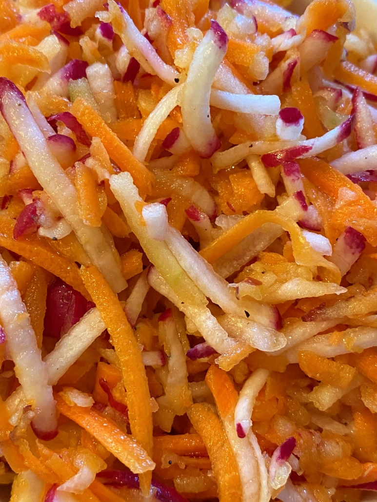 apple slaw with shredded carrots and radishes