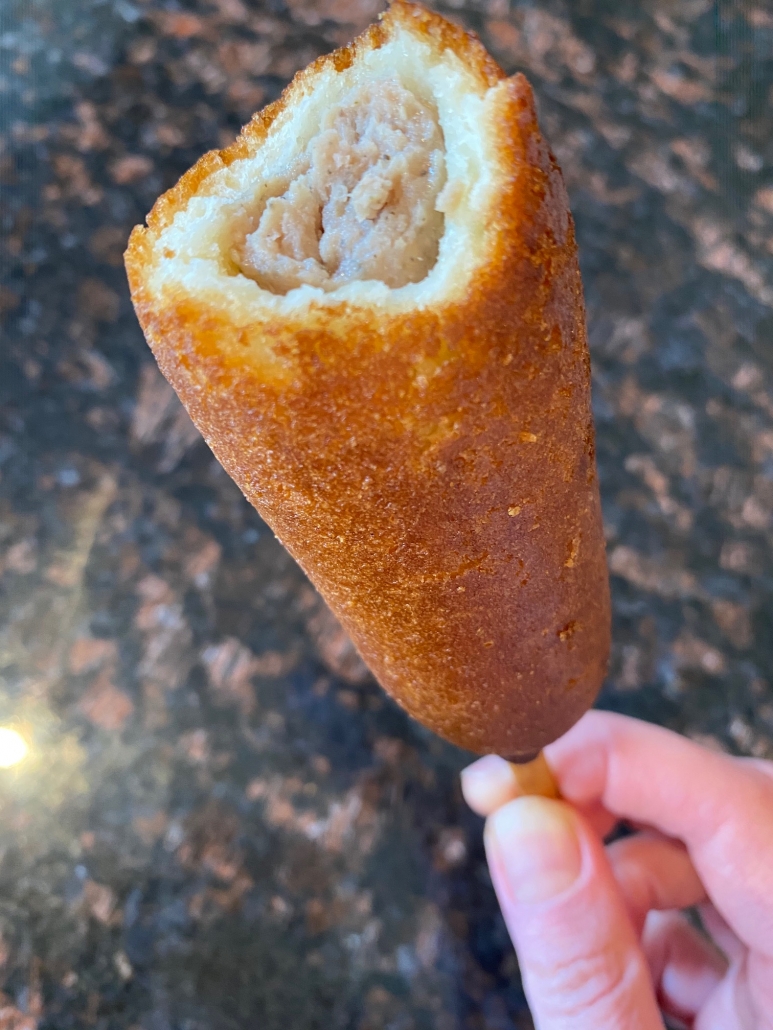 a bite bitten out of pancake sausage stick 