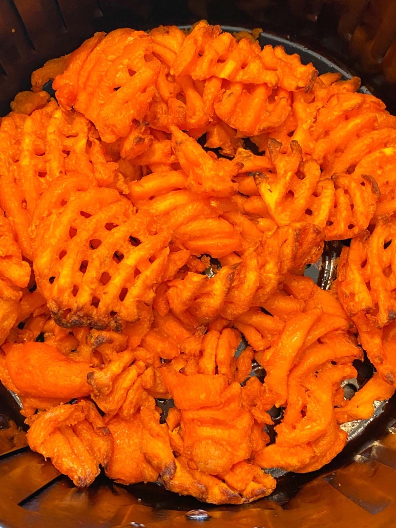 close up of sweet potato waffle fries in air fryer