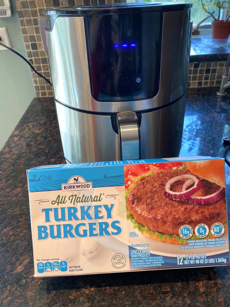 package of frozen turkey burgers in front it air fryer