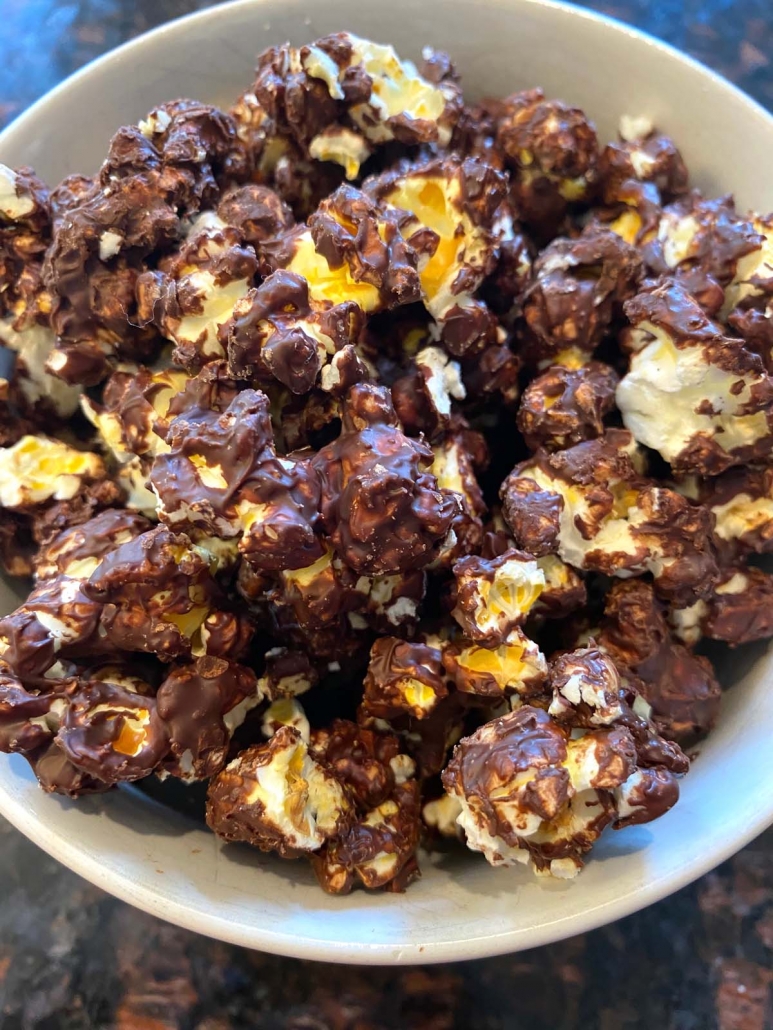 close up of chocolate covered popcorn in a bowl