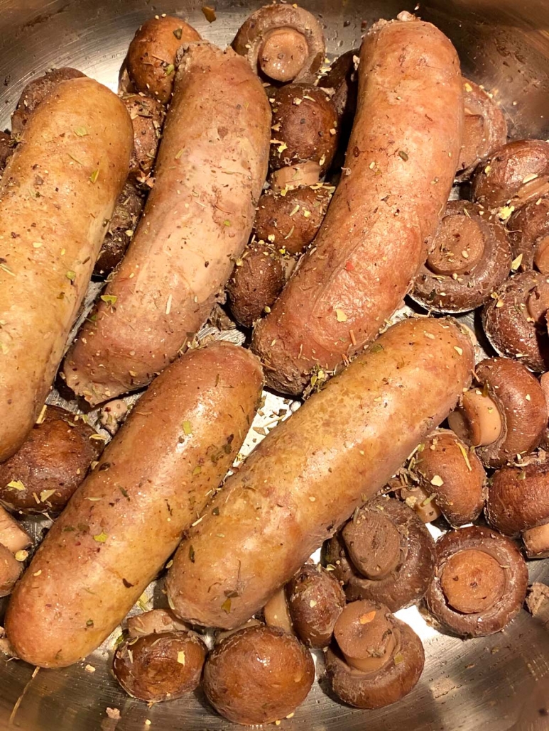 close up of cooked sausages and mushrooms