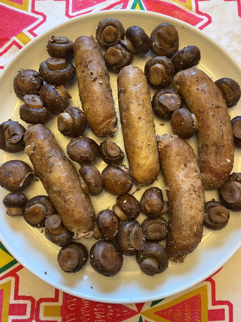 cooked sausages and mushrooms on a plate