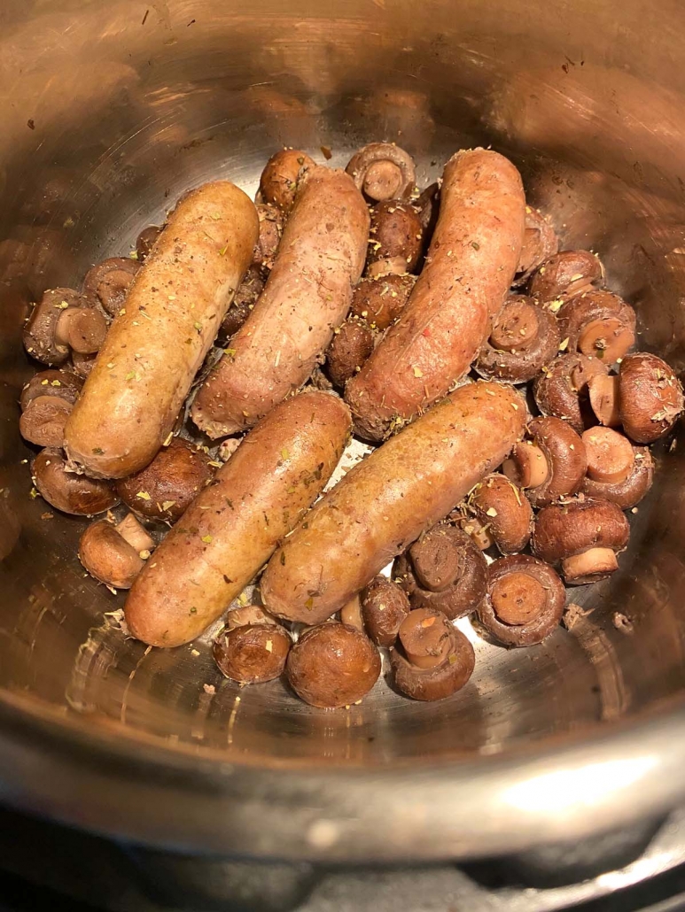 close up of sausages and mushrooms in the instant pot