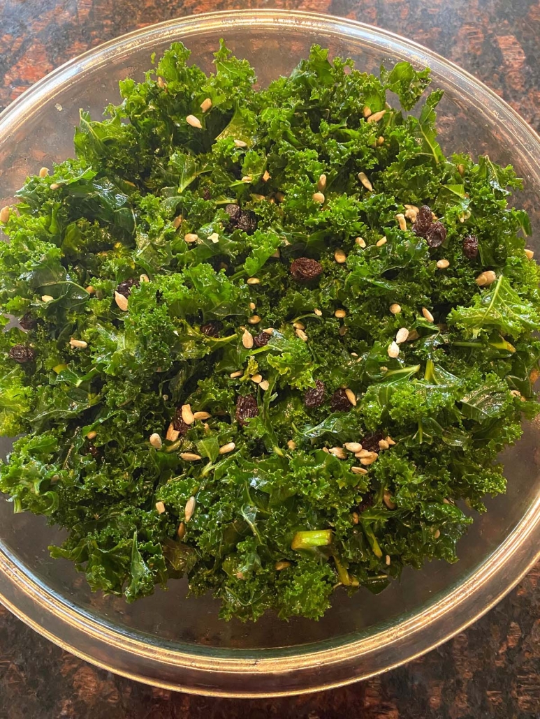 kale salad with raisins in bowl