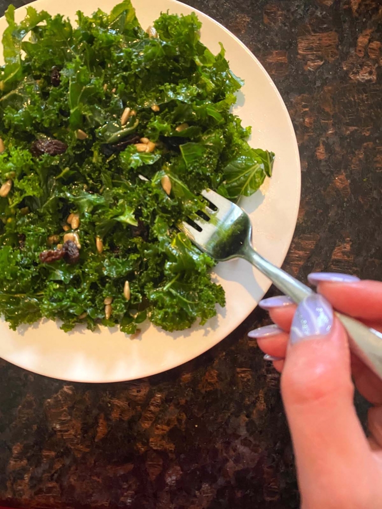 kale salad on plate with a fork