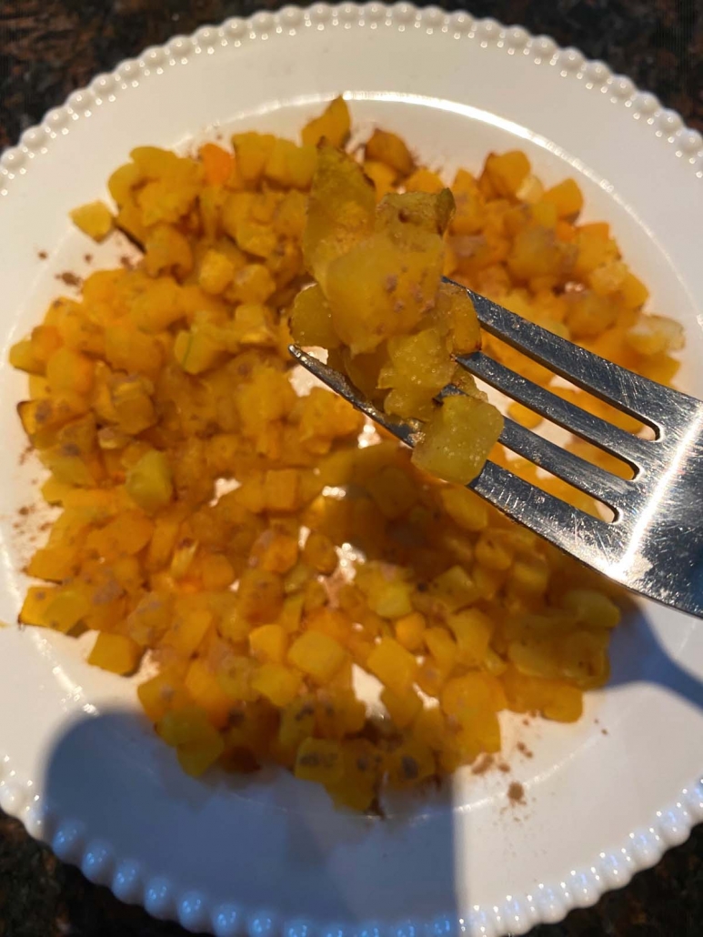 eating butternut squash with a fork