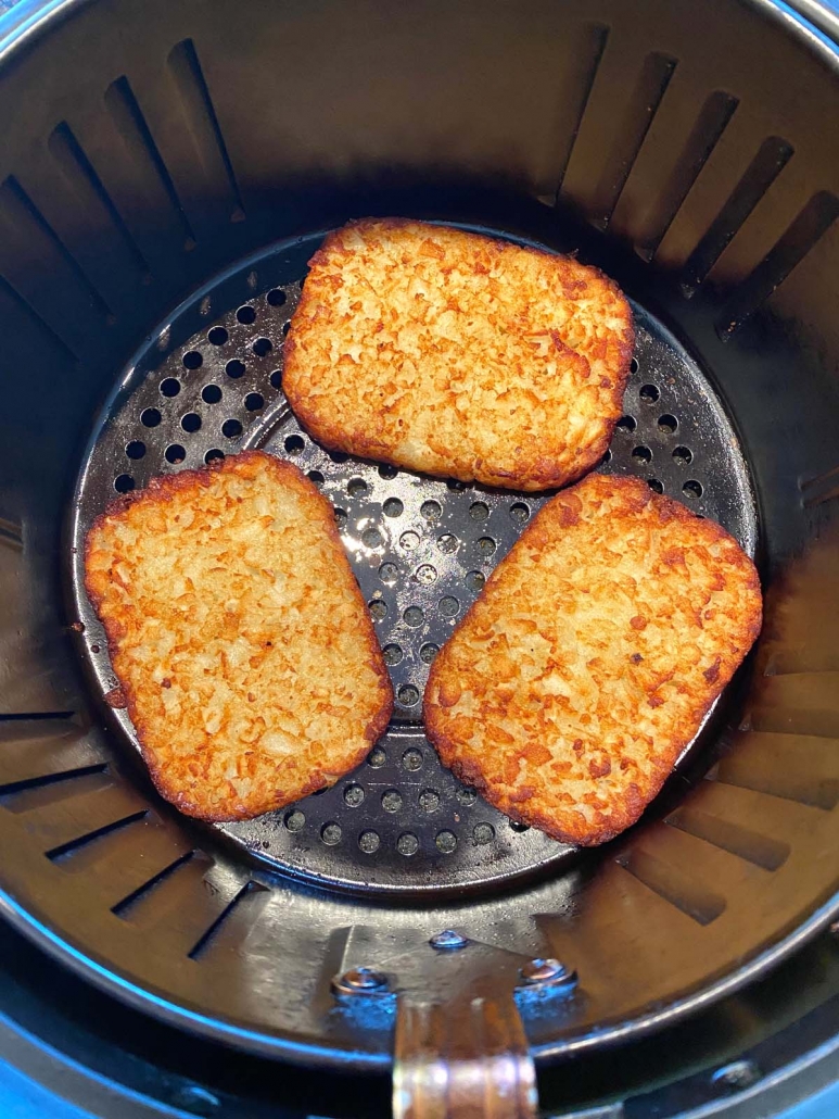 close up of hash brown patties in the air fryer