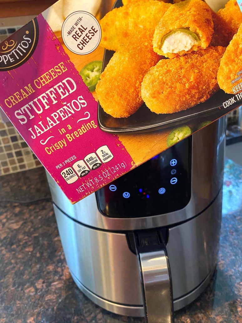 package of frozen jalapeno poppers in front of air fryer