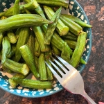 Air-fried okra on a plate, with a fork ready to eat.