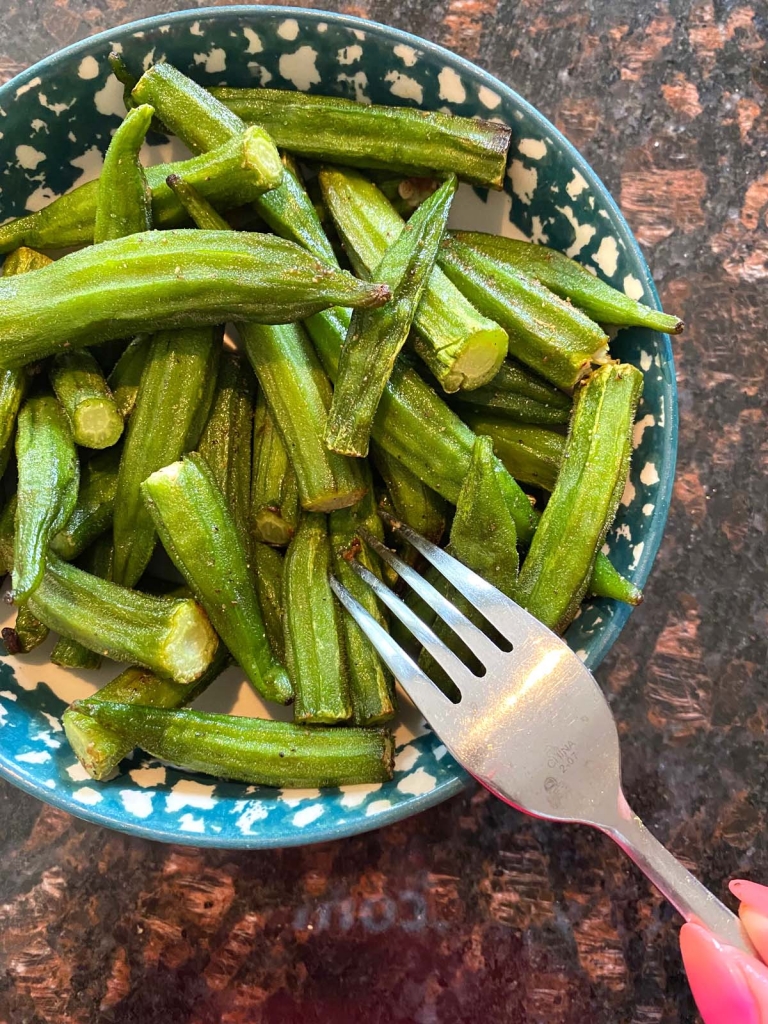 Air-fried okra on a plate, with a fork ready to eat.