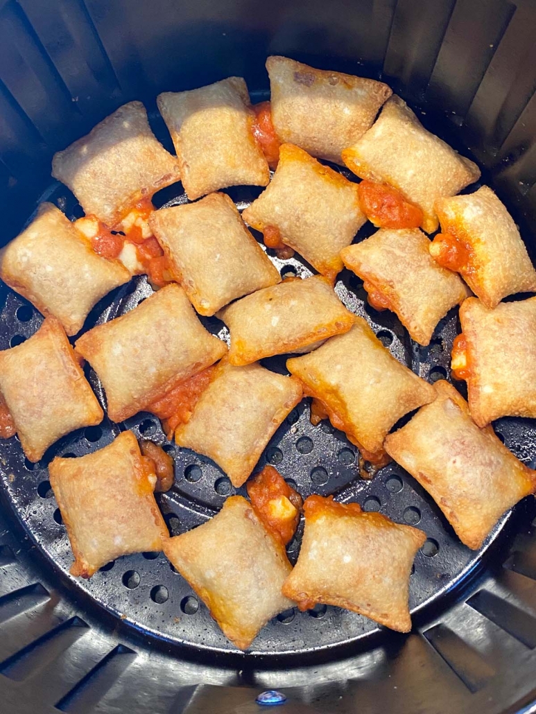 close up of cooked pizza rolls in the air fryer