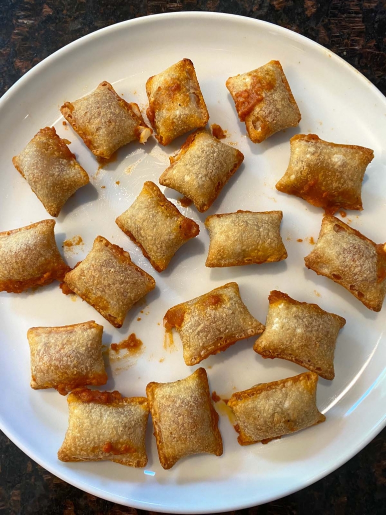 cooked pizza rolls on a white plate