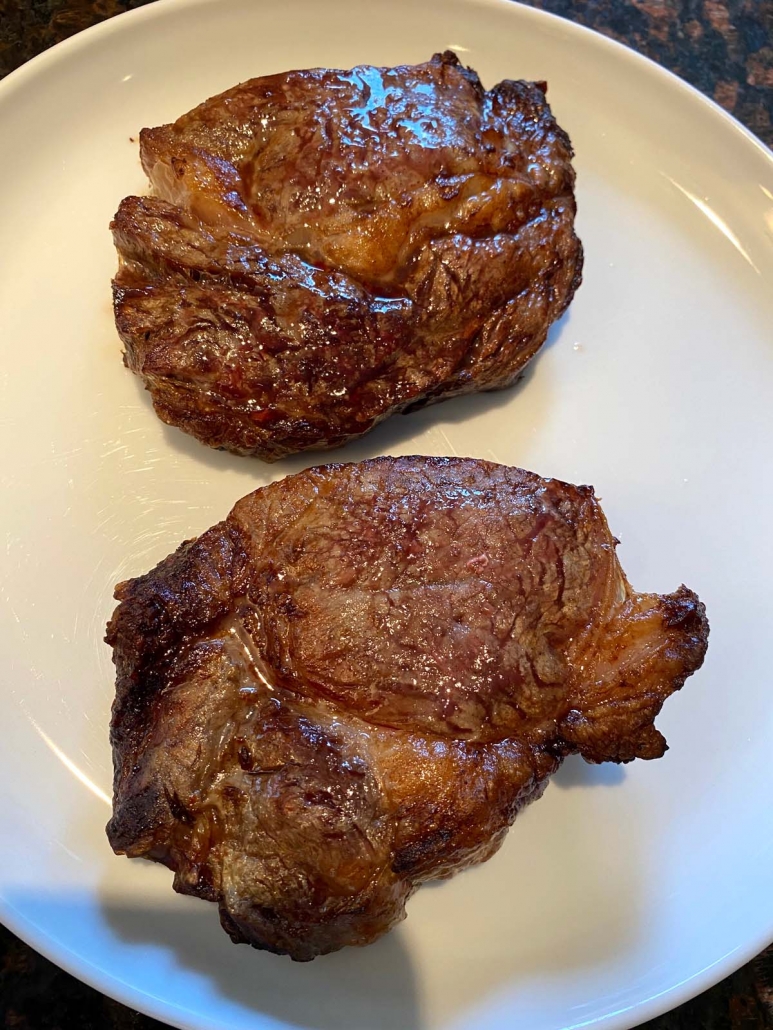 perfect ribeye steaks on a white plate 