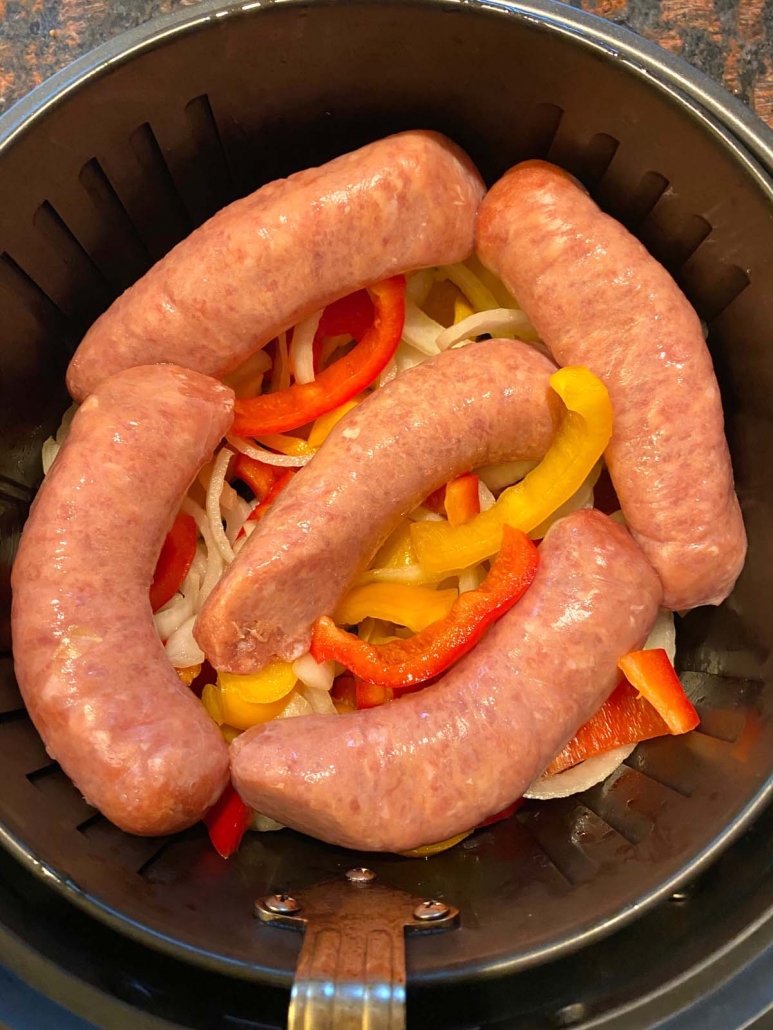 adding raw Italian sausages to air fryer basket 