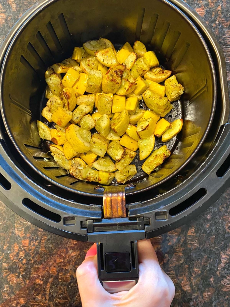 cooking yellow summer squash in the air fryer basket