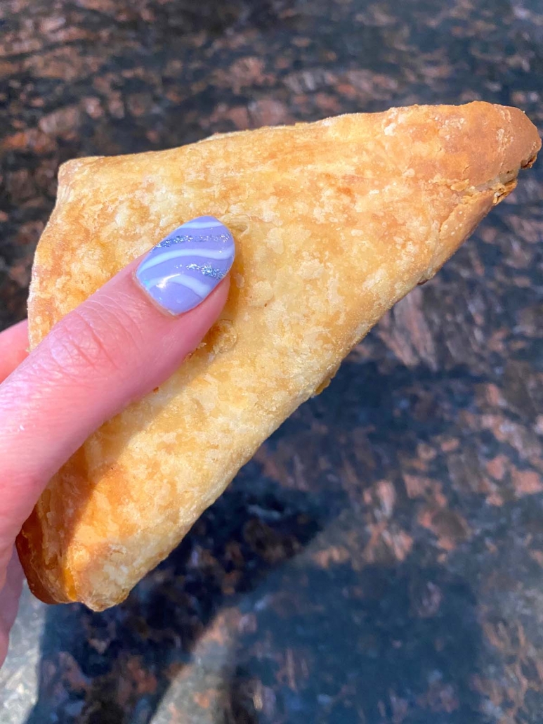 hand holding apple turnover