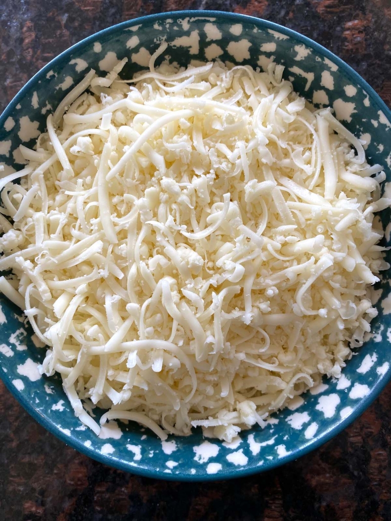close up of bowl filled with shredded cheese