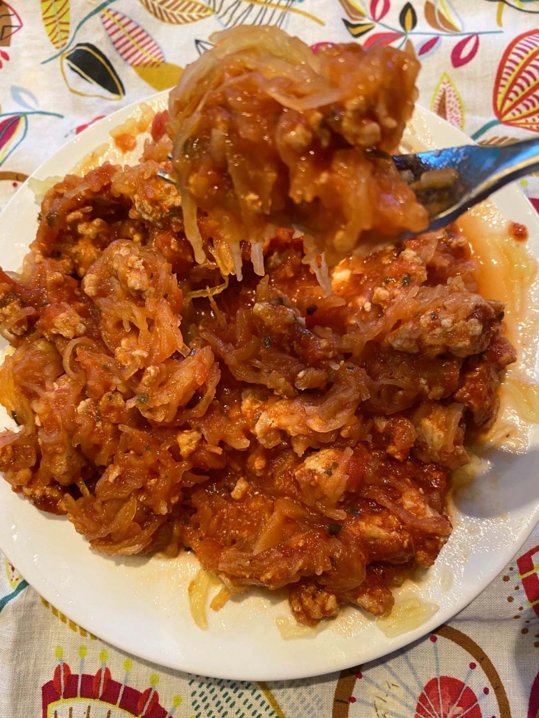 fork holding some spaghetti squash with meat sauce