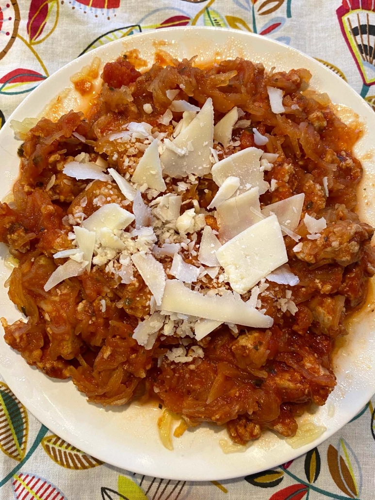 spaghetti squash with meat sauce in a bowl covered with parmesan cheese