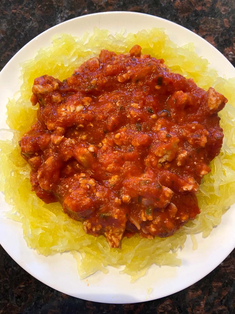 meat sauce on top of spaghetti squash on plate