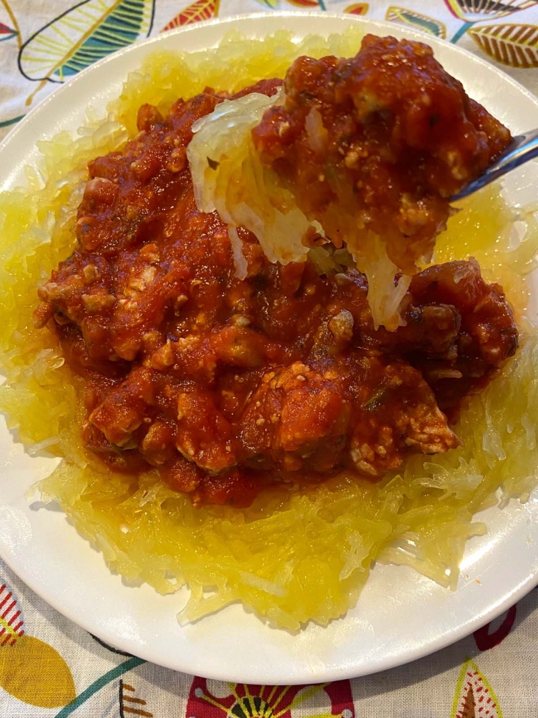 fork holding spaghetti squash with meat sauce on top