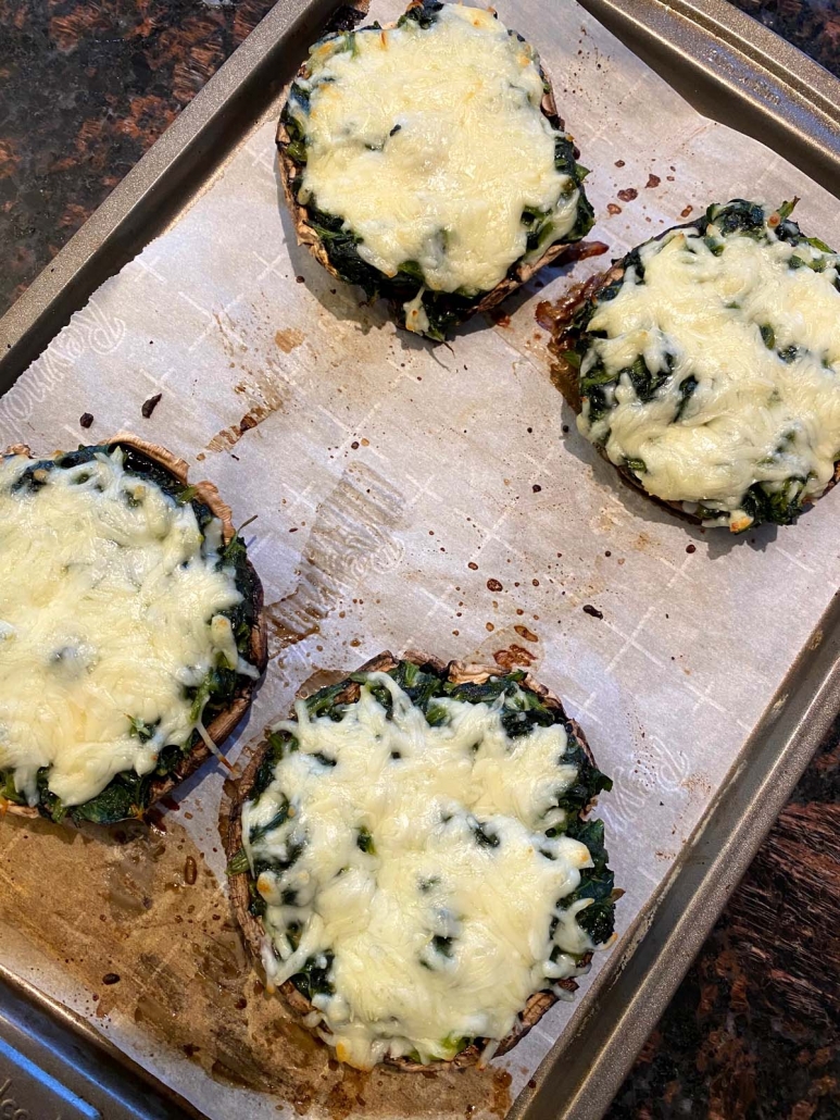 Baked spinach stuffed portobello mushrooms topped with melted mozzarella cheese.