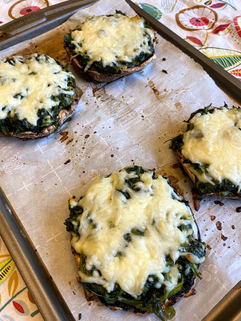 Freshly baked spinach stuffed portobello mushrooms with golden melted cheese.