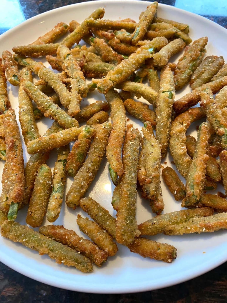 close up of breaded green beans on plate