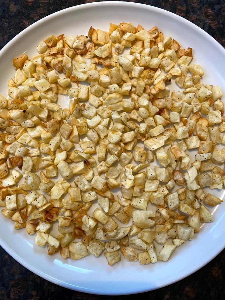 air fryer cooked diced potatoes on plate