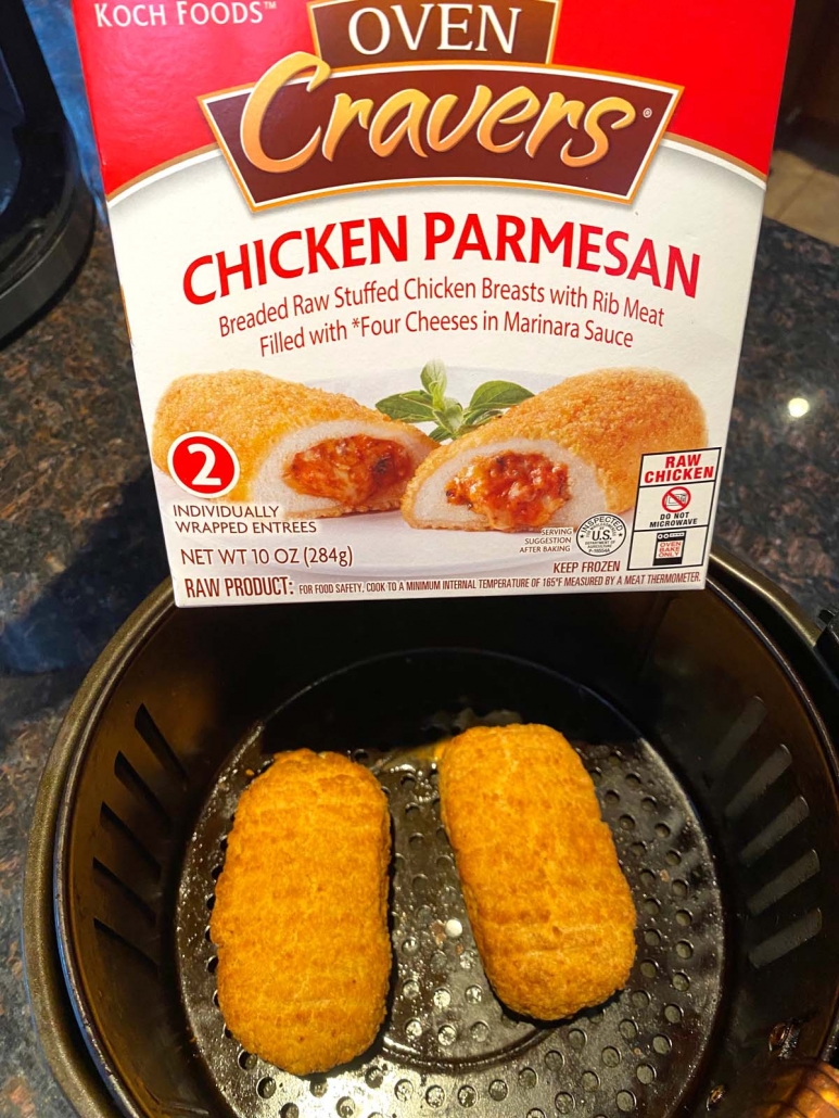 oven cravers chicken parmesan box above air fryer with chicken in basket