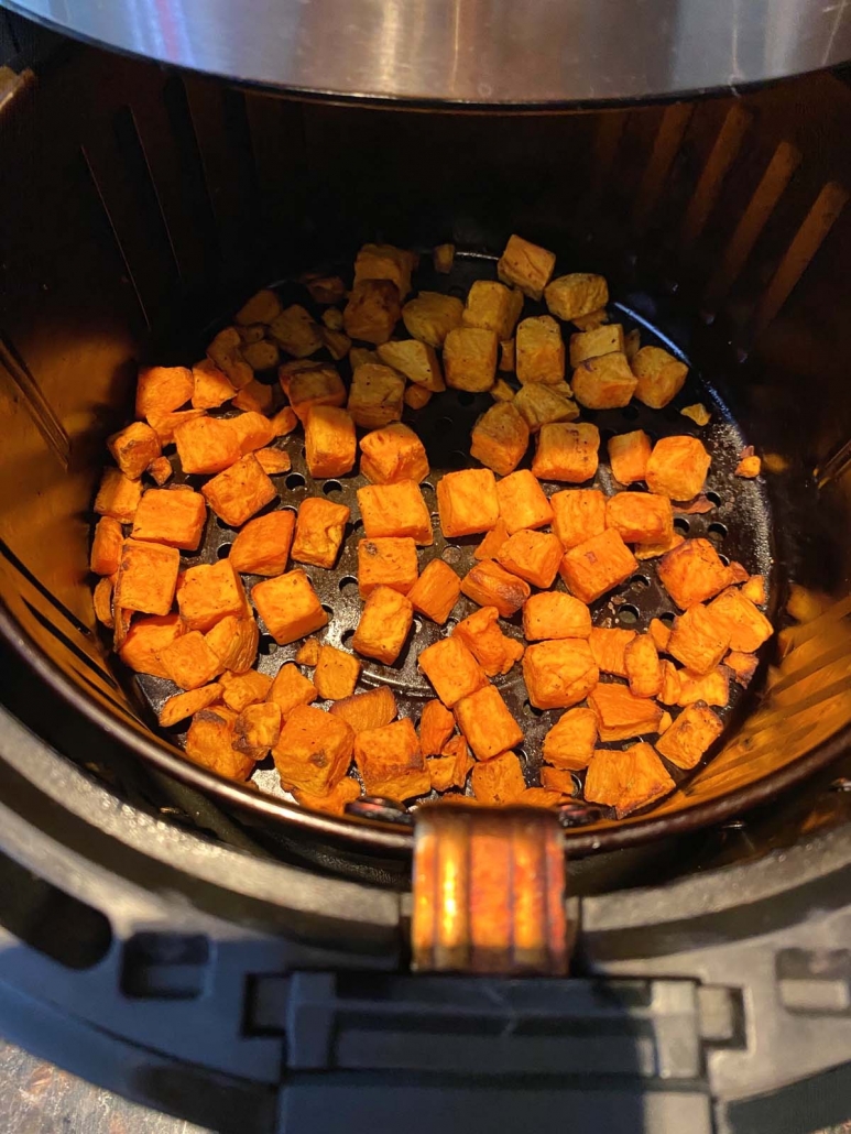 close up of sweet potatoes in air fryer