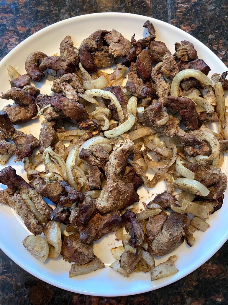 beef liver and onions on a white plate 