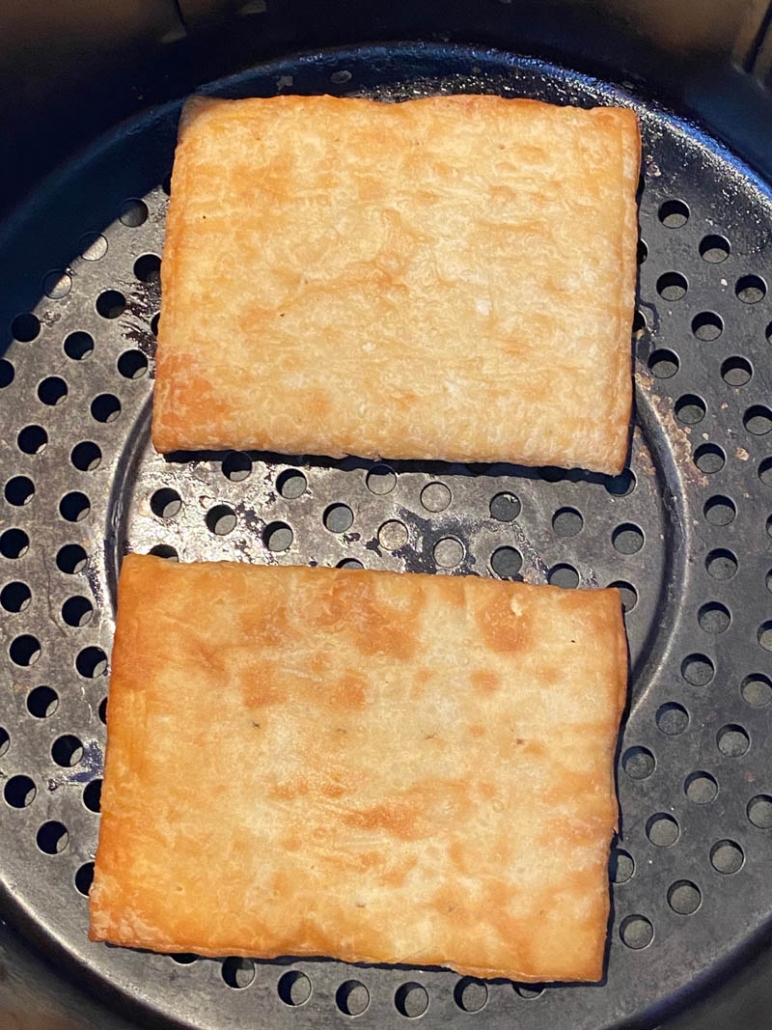 close up of two toaster strudels in an air fryer