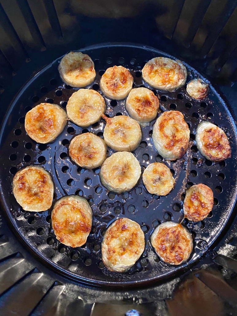 close up of banana slices cooking in air fryer