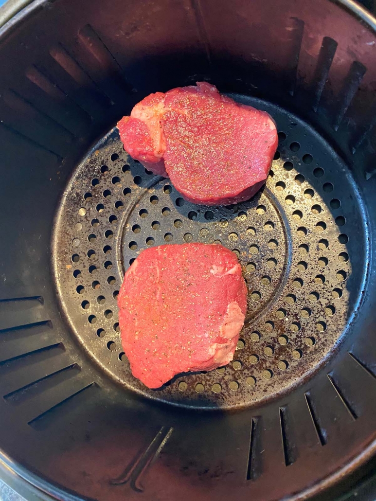 filet mignon steak in the air fryer basket