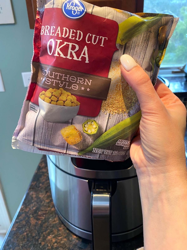 hand holding package of frozen breaded okra