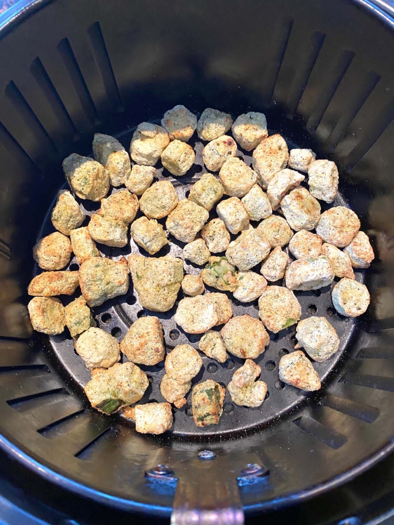 air fryer basket filled with frozen breaded okra pieces