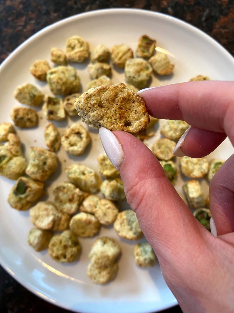 hand holding piece of air fried breaded okra