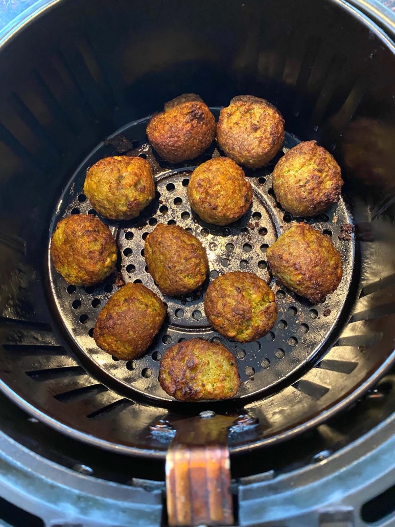 air fryer basket filled with frozen falafel