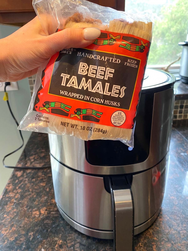 package of beef tamales held in front of air fryer