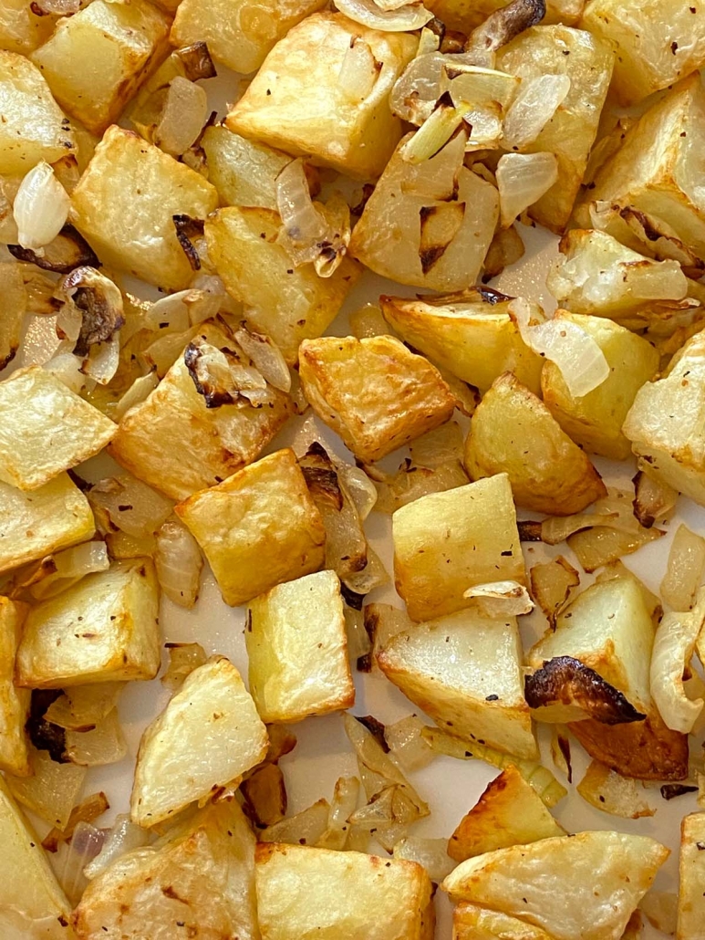 close up of air fried onions and potatoes on a plate