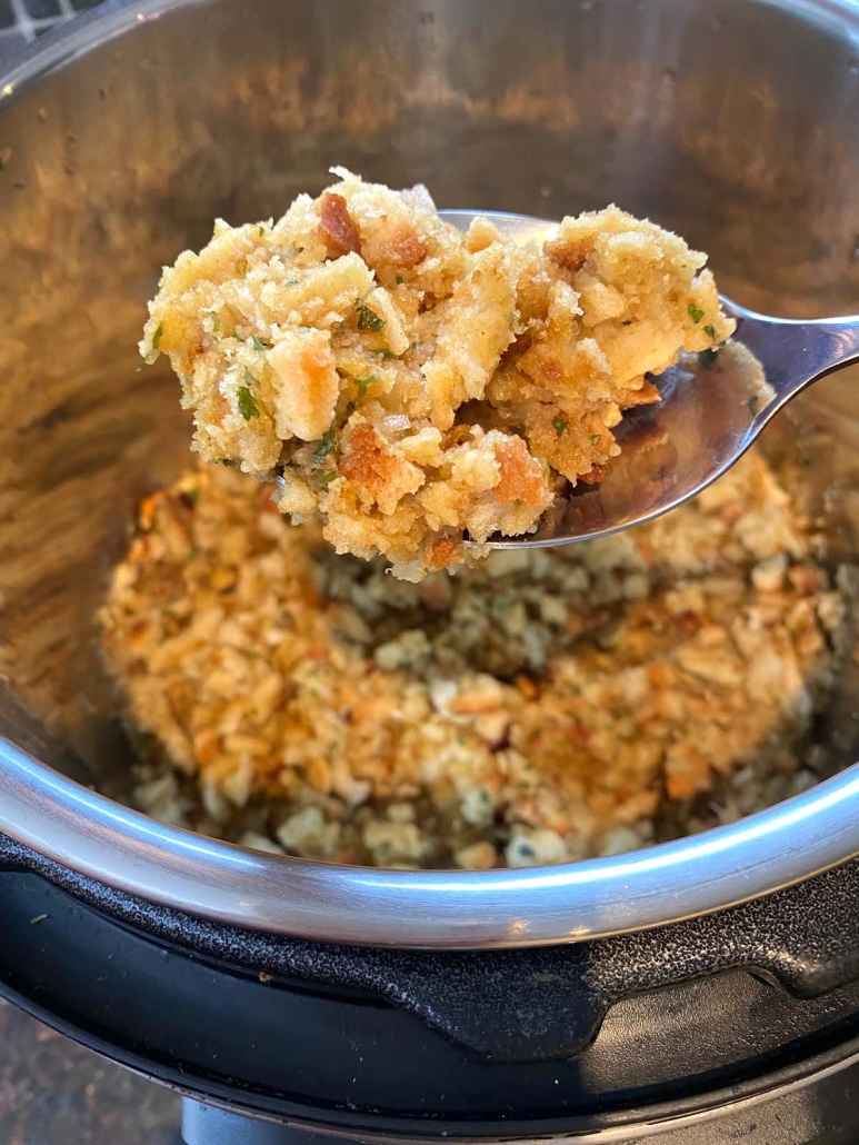 spoon scooping up stove top stuffing from instant pot