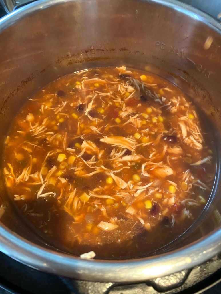 broth, chicken, beans, corn, and salsa in instant pot