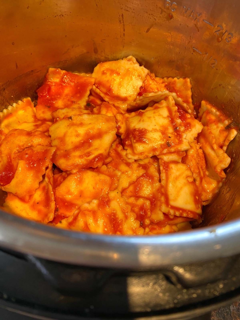 instant pot filled with cooked ravioli in tomato sauce
