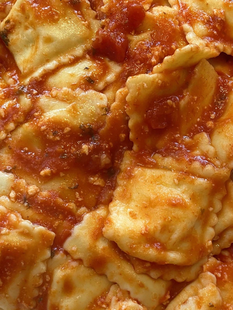 close up of ravioli with tomato sauce