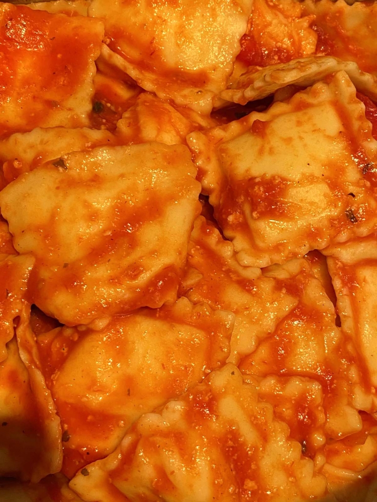 close up of ravioli with tomato sauce